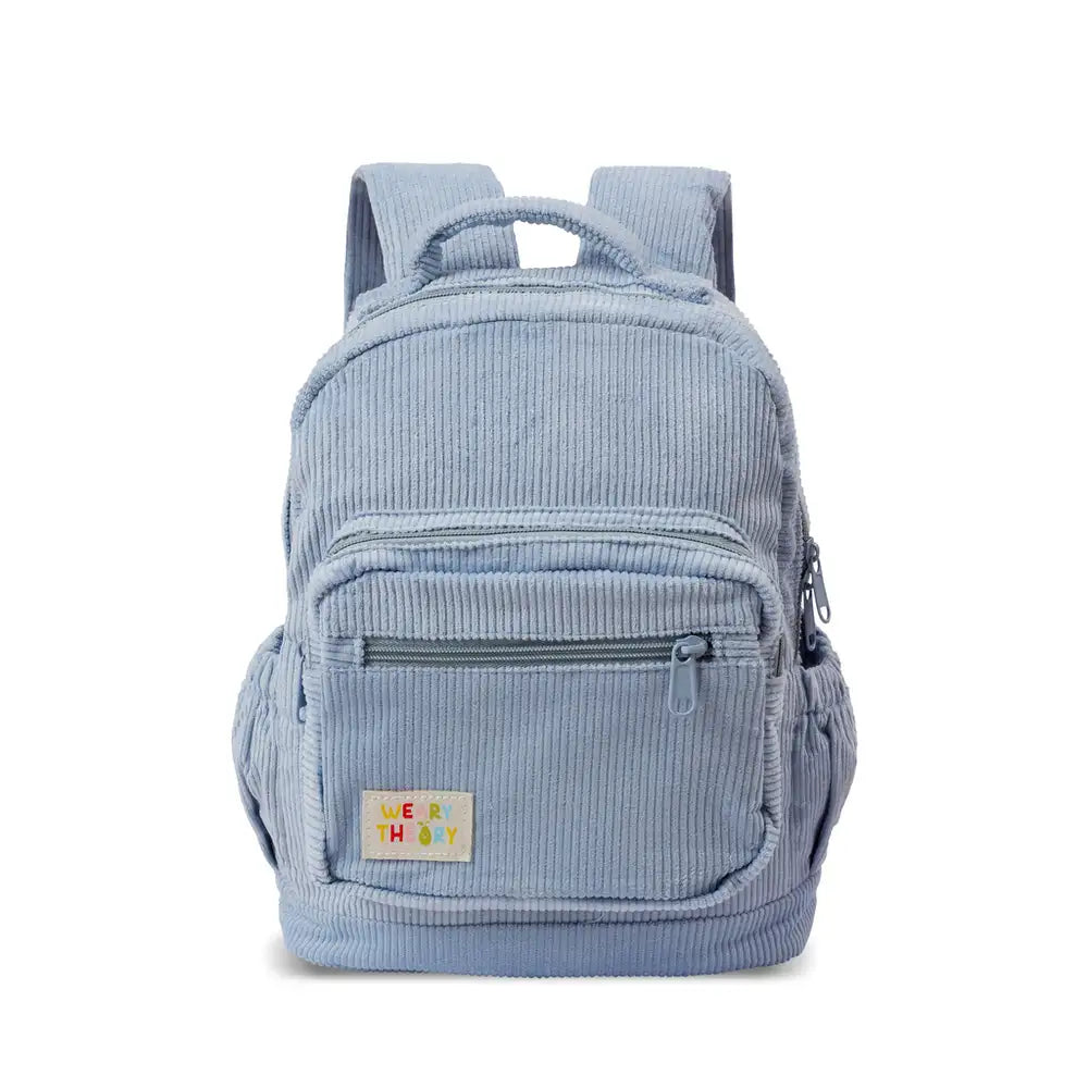 Personalised toddler backpack in corduroy – blue color. Child wearing custom name daycare backpack
