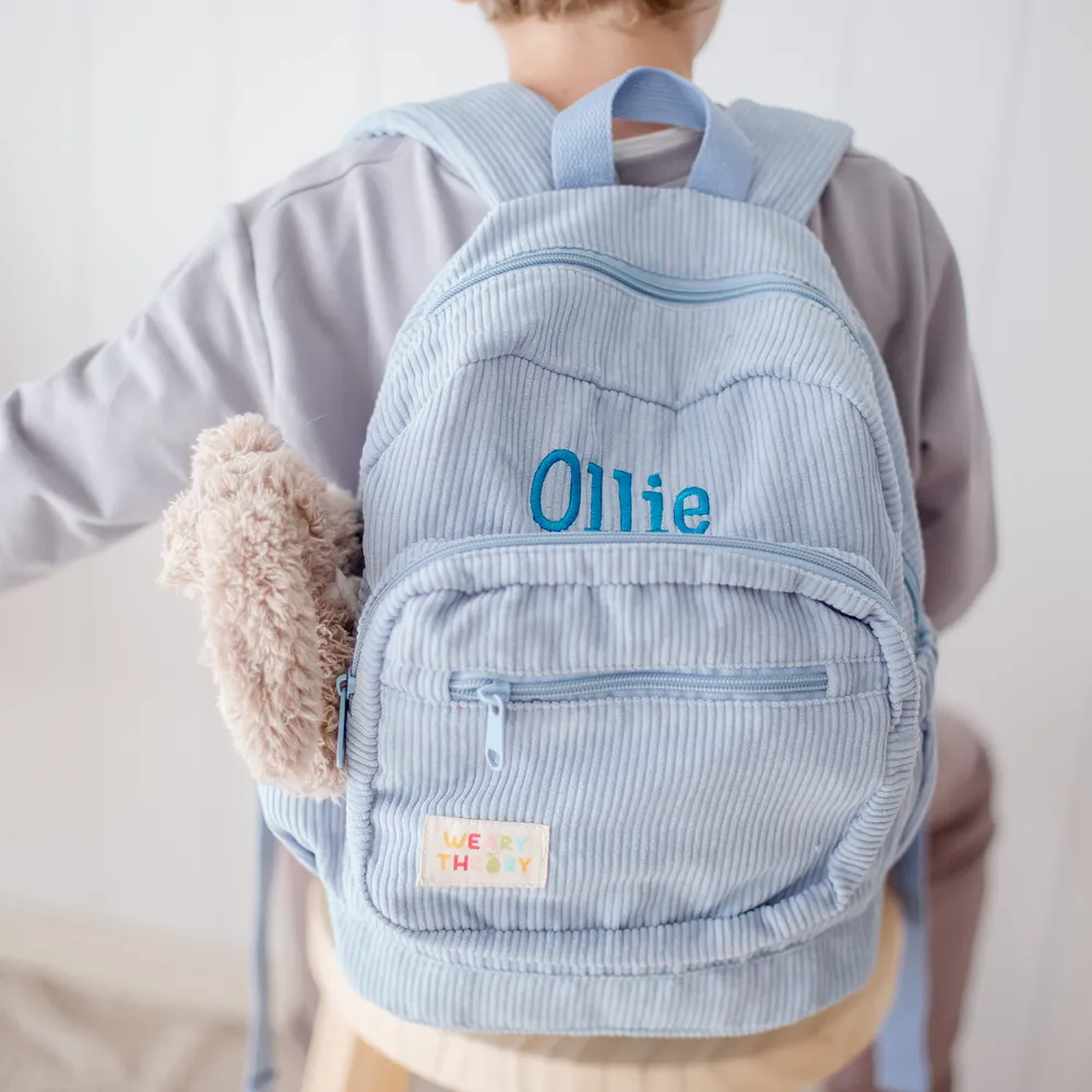 Child wearing the Blueberry Corduroy Backpack