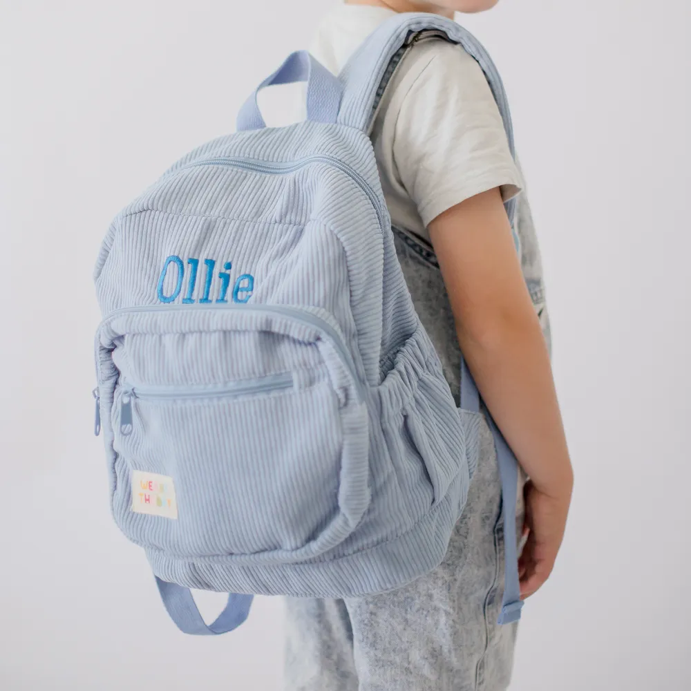 Child wearing the Blueberry Corduroy Backpack