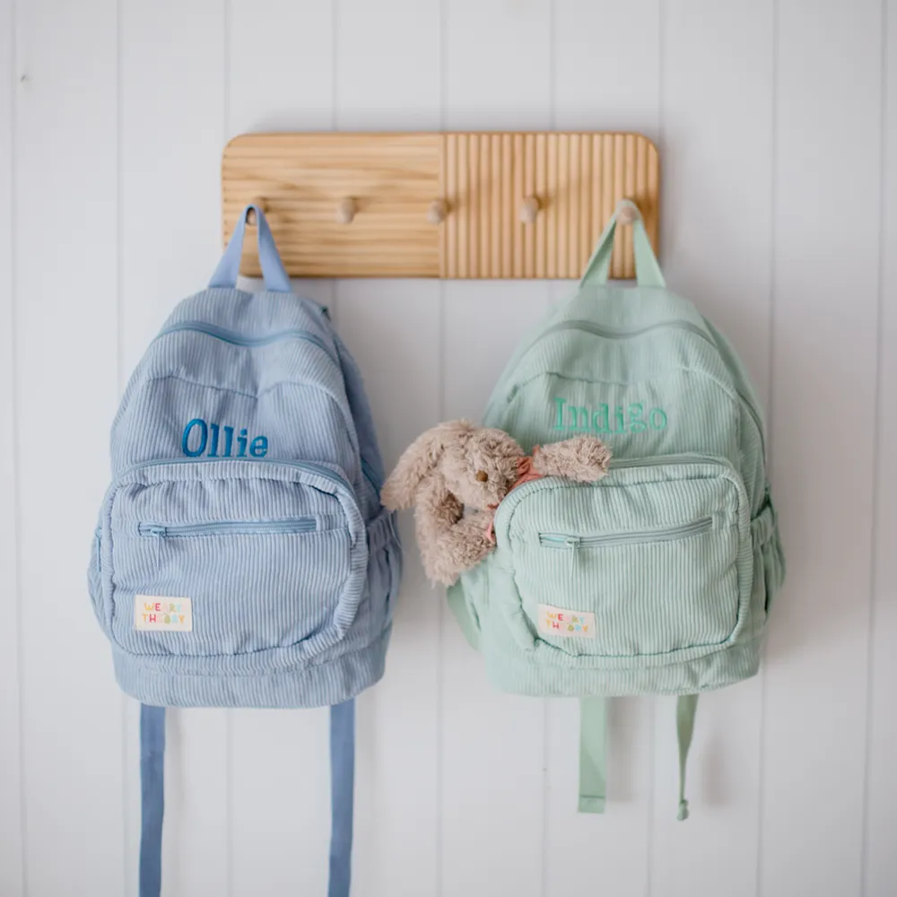 Blueberry Corduroy Backpack on a peg hook