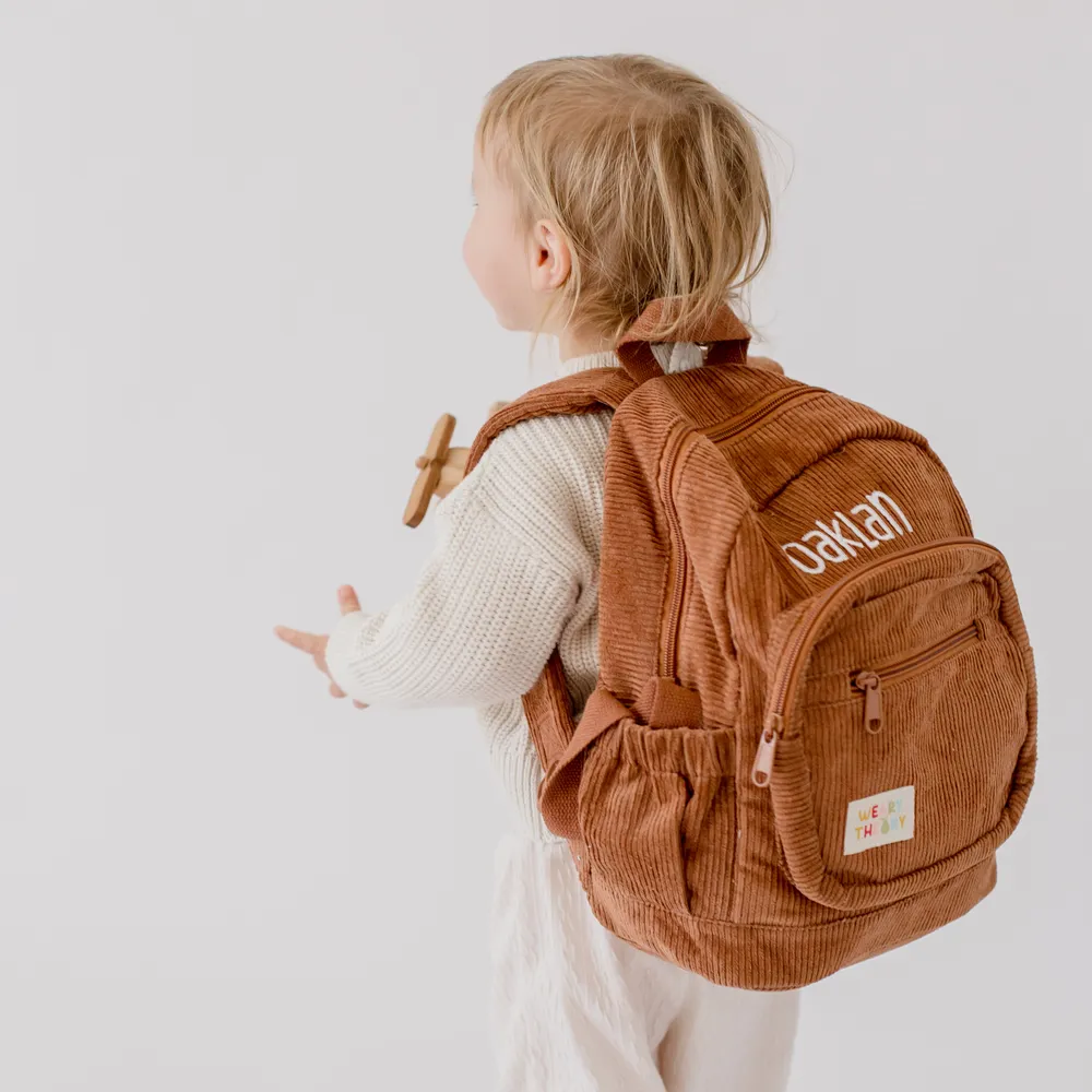 Child wearing the Chocolate Corduroy Backpack