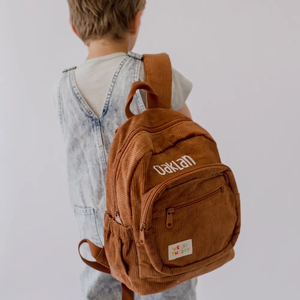 Child wearing the Chocolate Corduroy Backpack