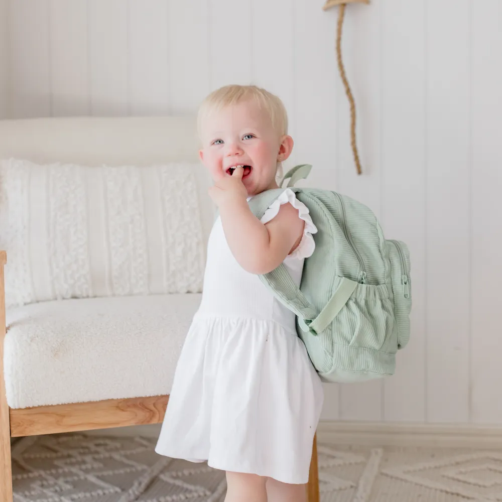 Child wearing the Pear Corduroy Backpack