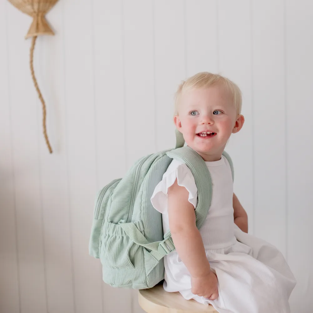 Child wearing the Pear Corduroy Backpack