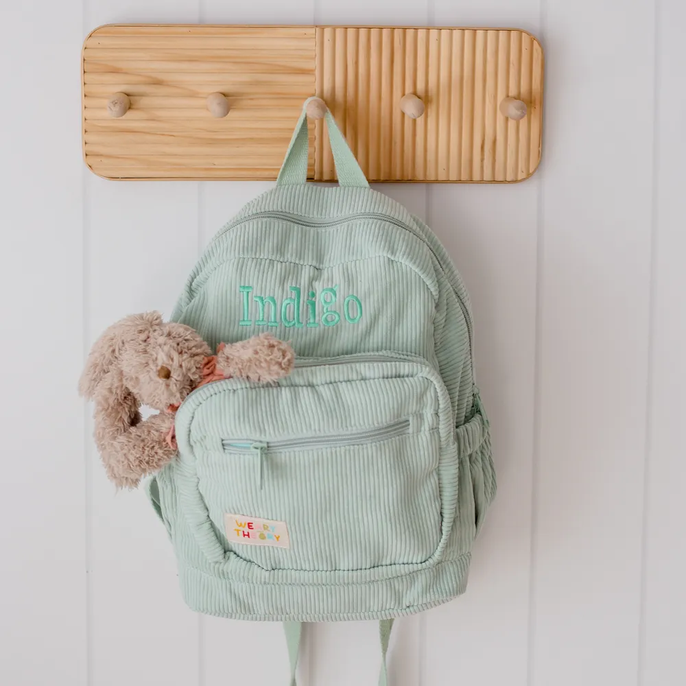 Pear Corduroy Backpack on a peg hook