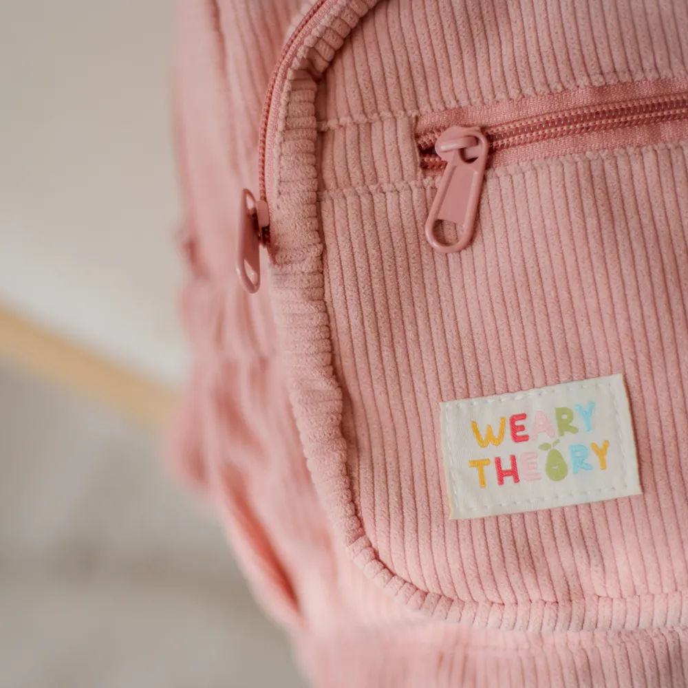 Strawberry Corduroy Backpack closeup showing the Weary Theory logo