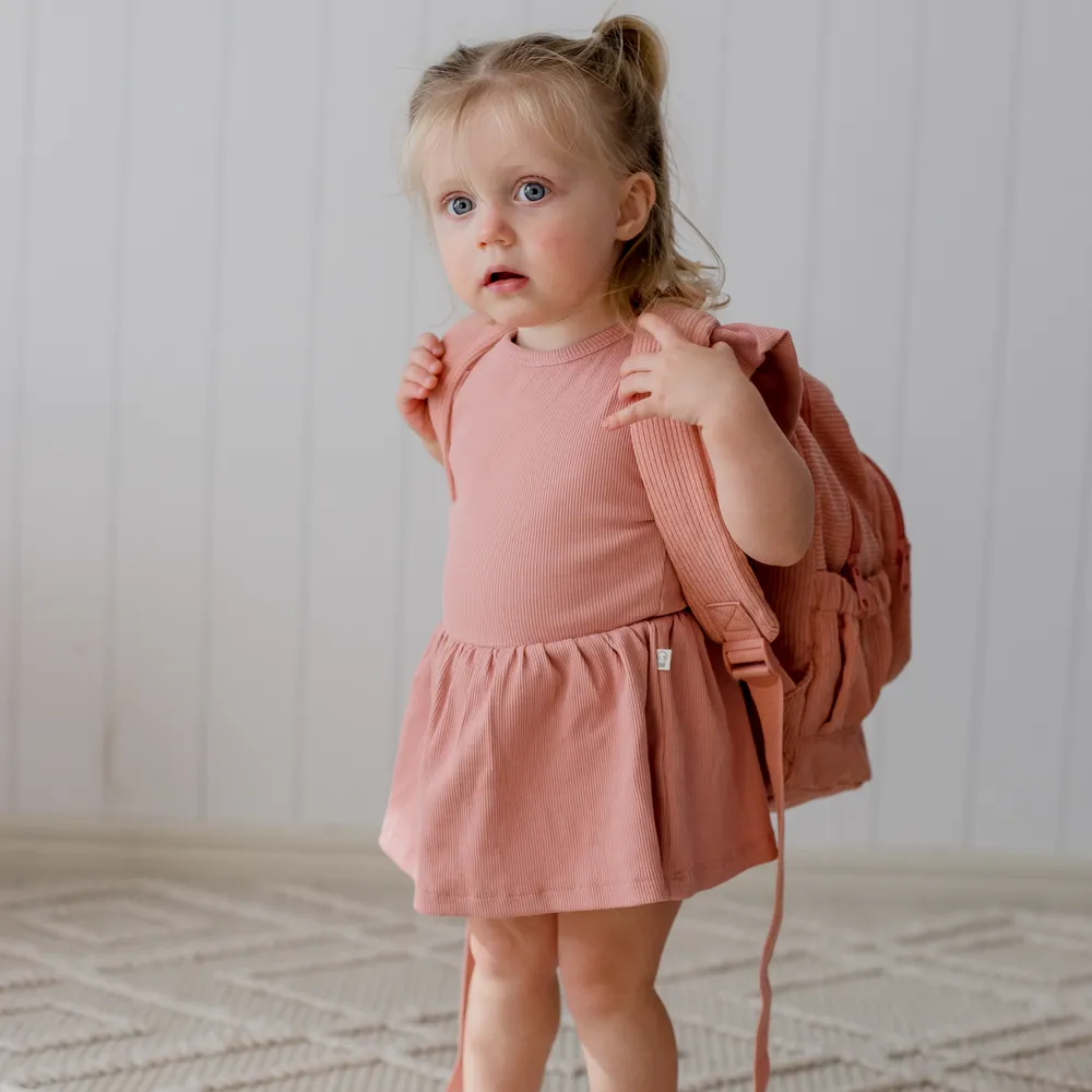 Child wearing the Strawberry Corduroy Backpack