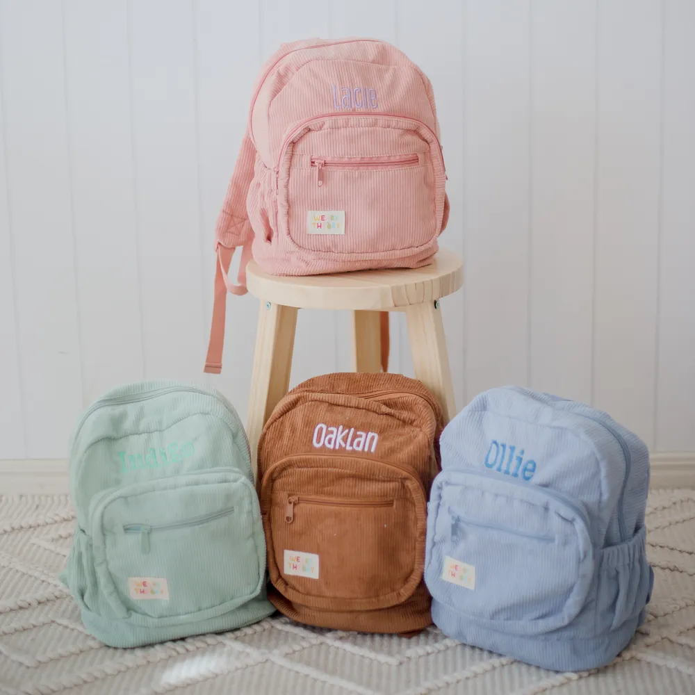 Backpacks arranged, with one on a stool