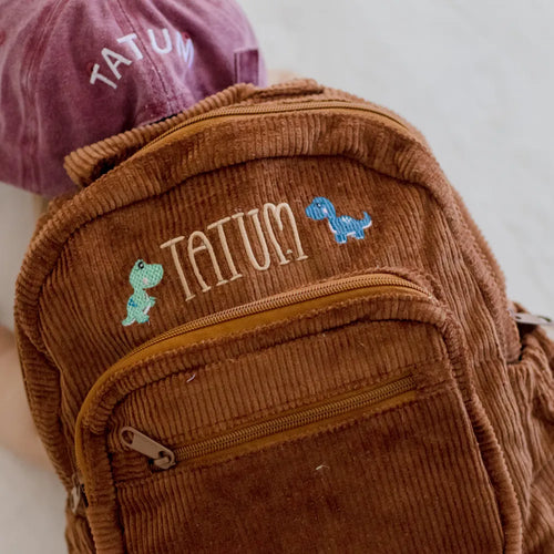 Personalised toddler backpack in corduroy – brown color. Child wearing custom name daycare backpack