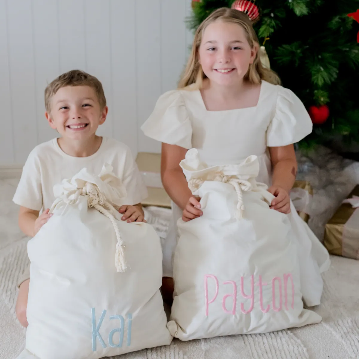 Two children enjoying their Santa sacks